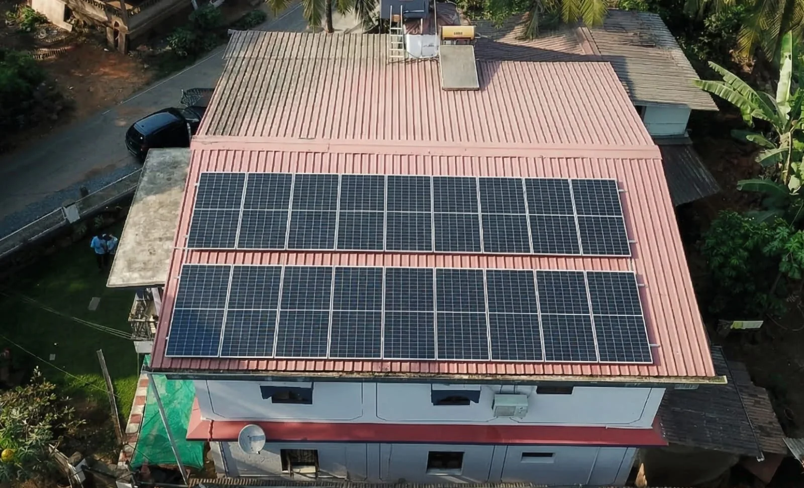 Dark solar array on a pale red tiled home