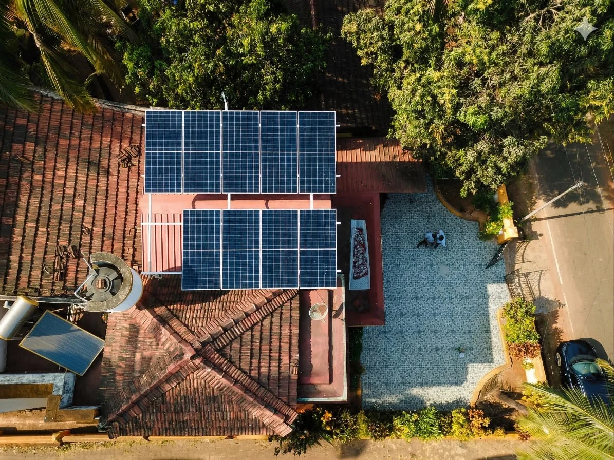 Two solar arrays beside a paved courtyard